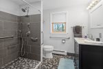 Newly renovated bathroom with accessible step-in shower and grab bars